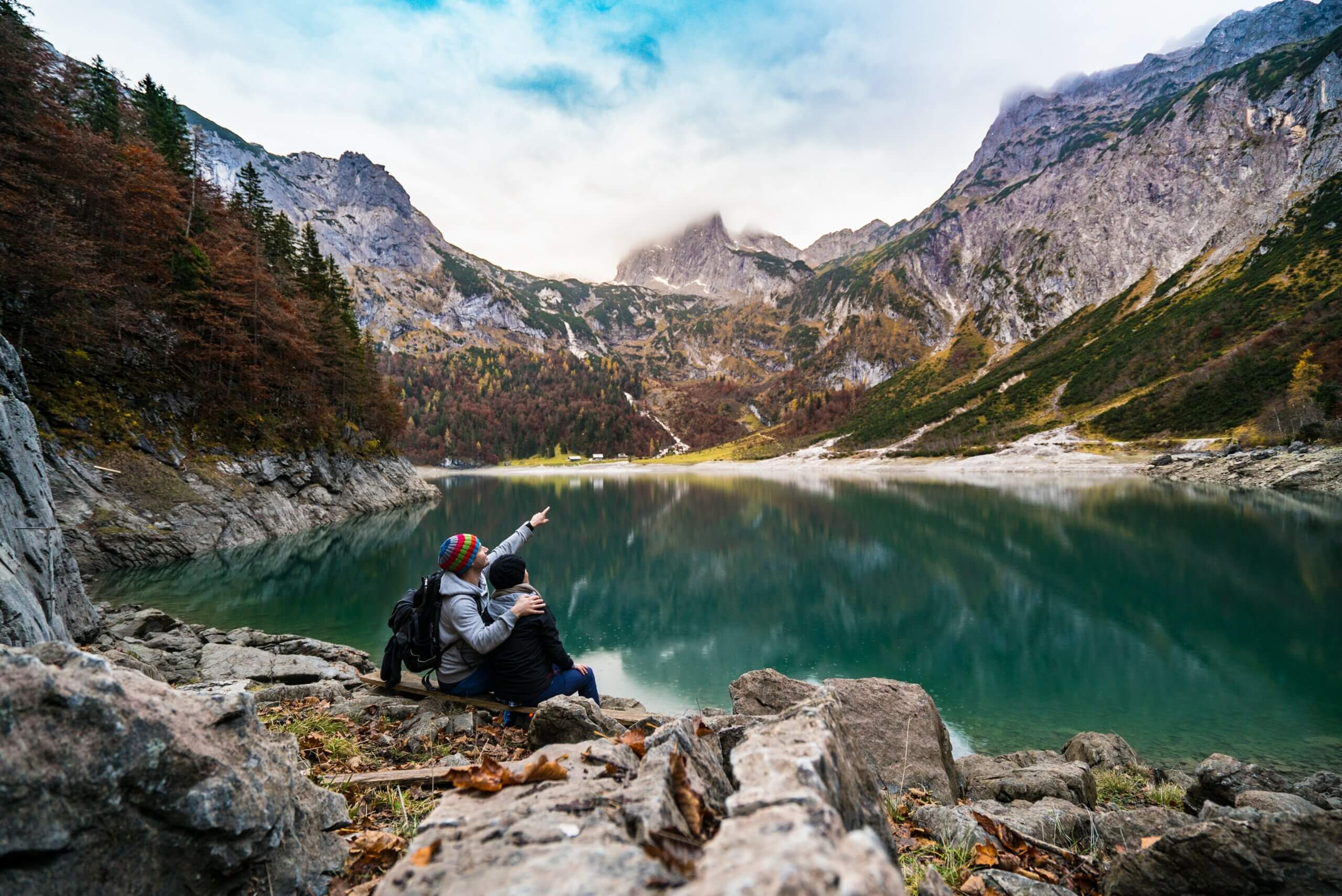 Couple looking at mountains over lake